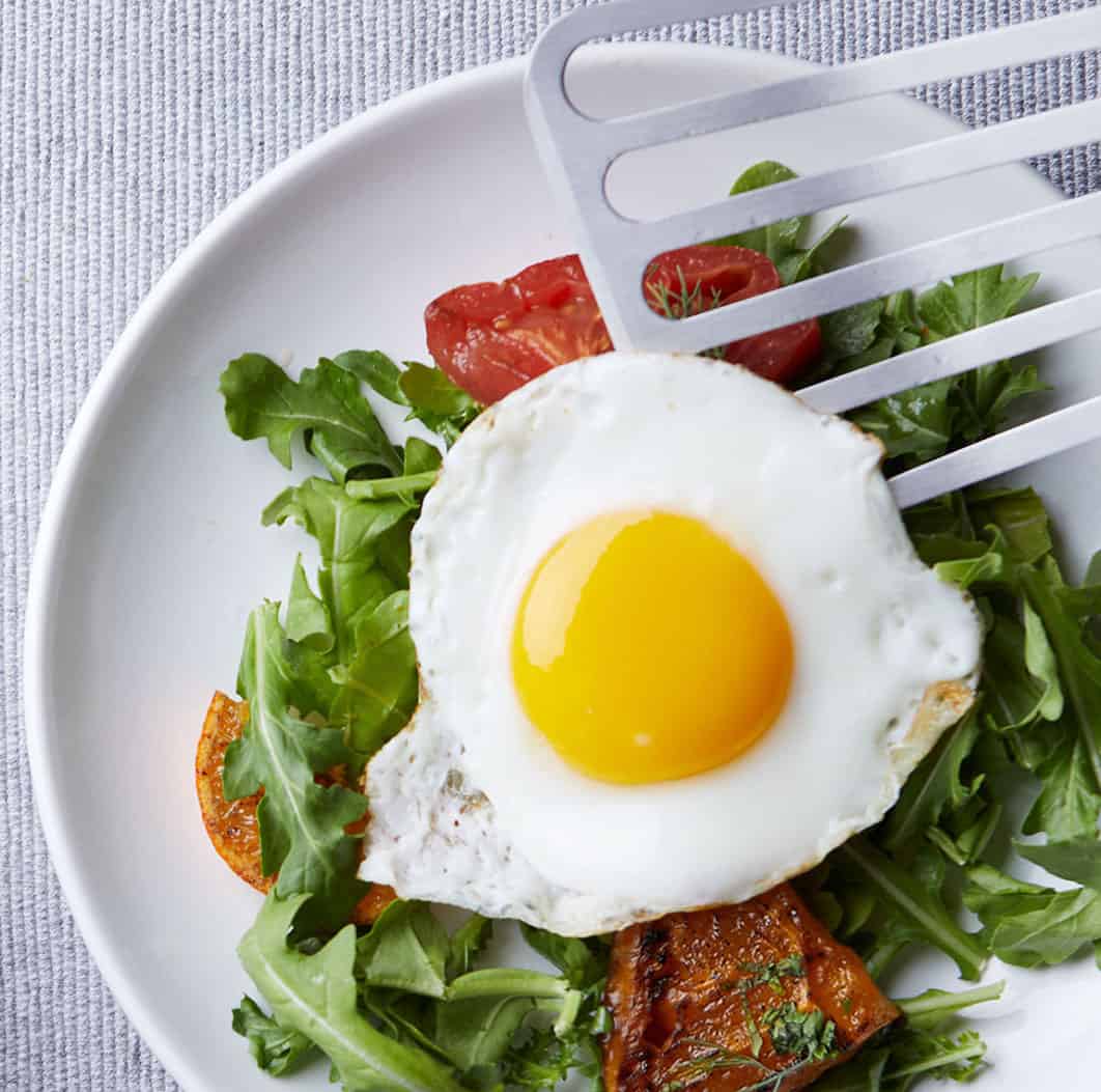 fried egg on a bed of greens