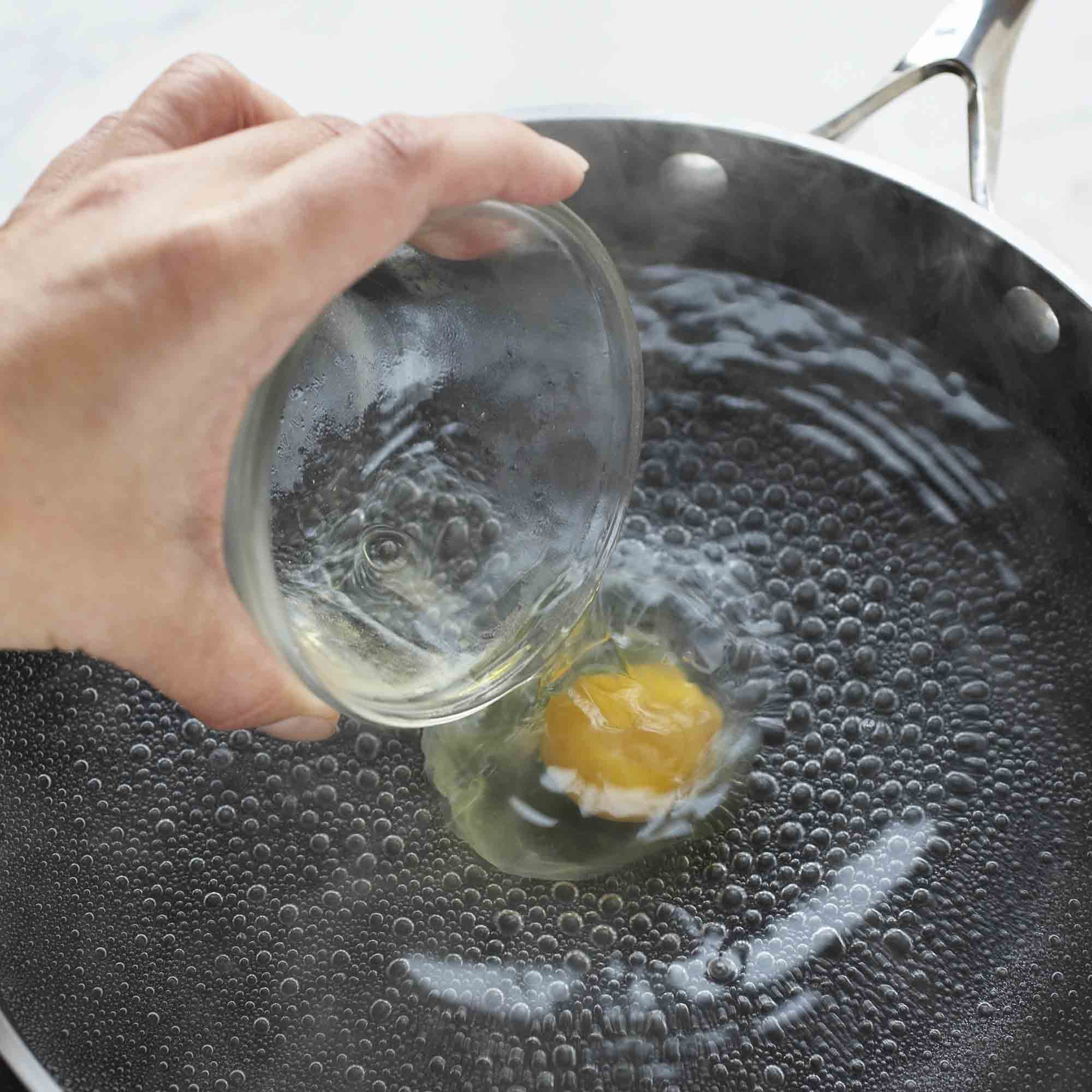 pouring egg into boiling water