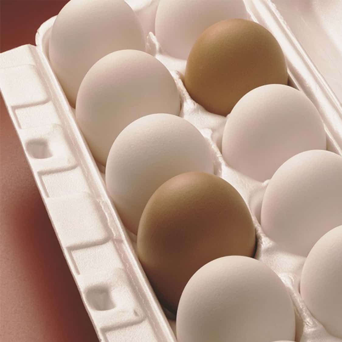 a carton of brown and white eggs