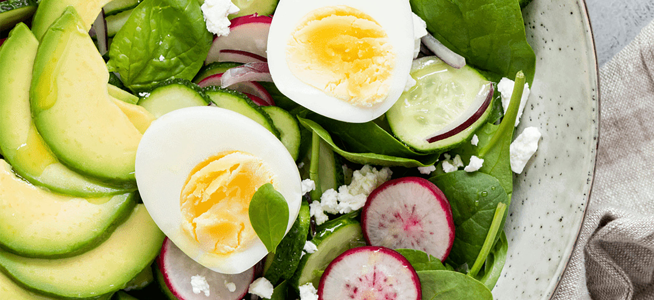 green salad with avocado, radish, and egg