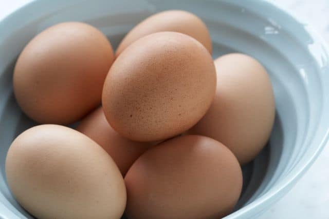 brown eggs in a blue bowl