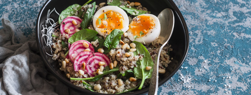 grain bowl with radishes, greens, and eggs