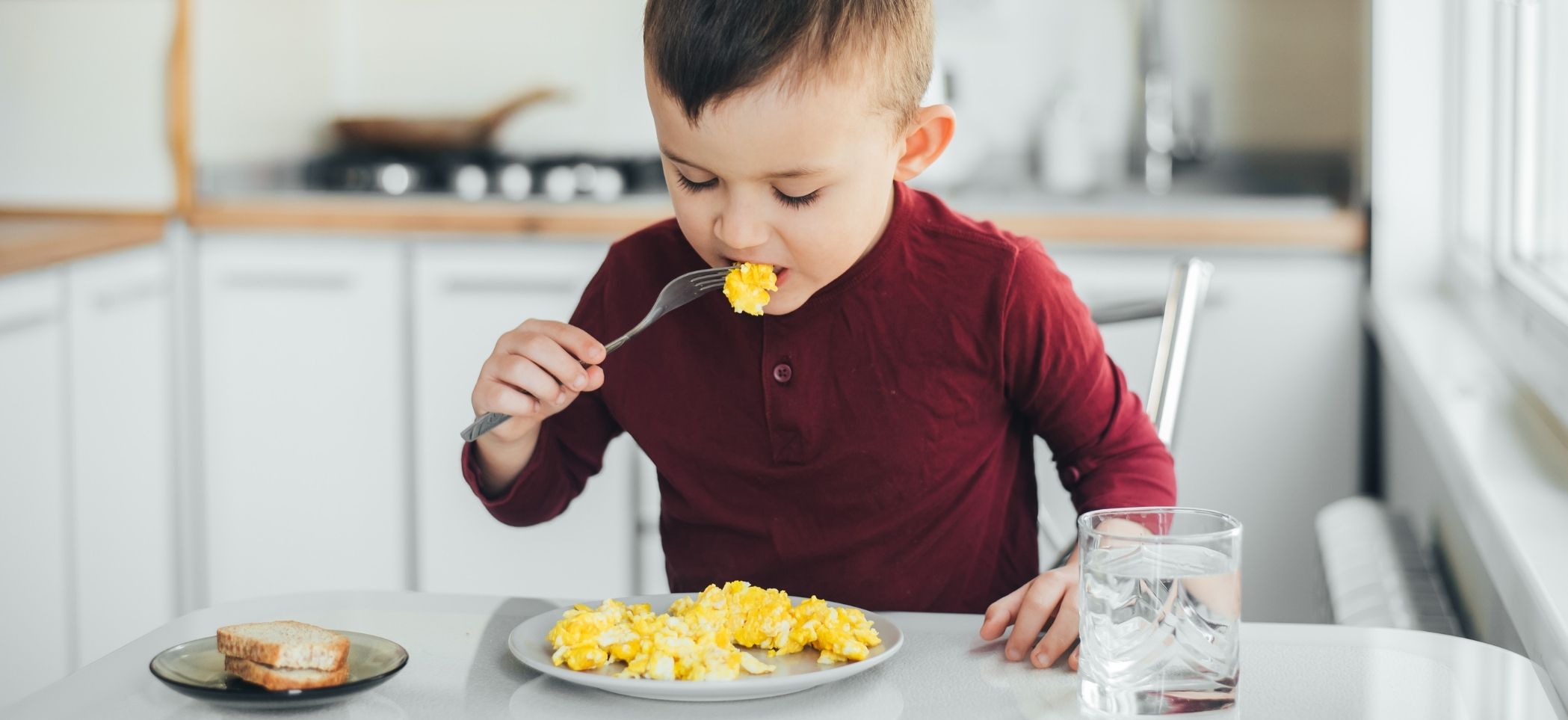 a child eats scrambled eggs