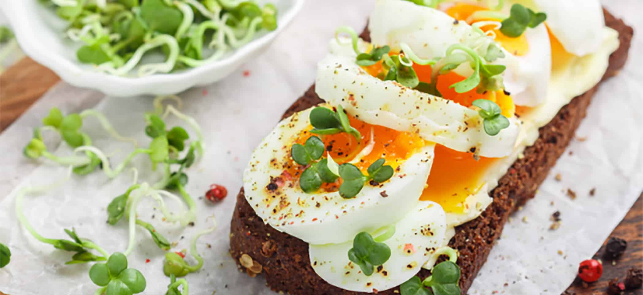 medium-boiled egg slices and pea sprouts on toast