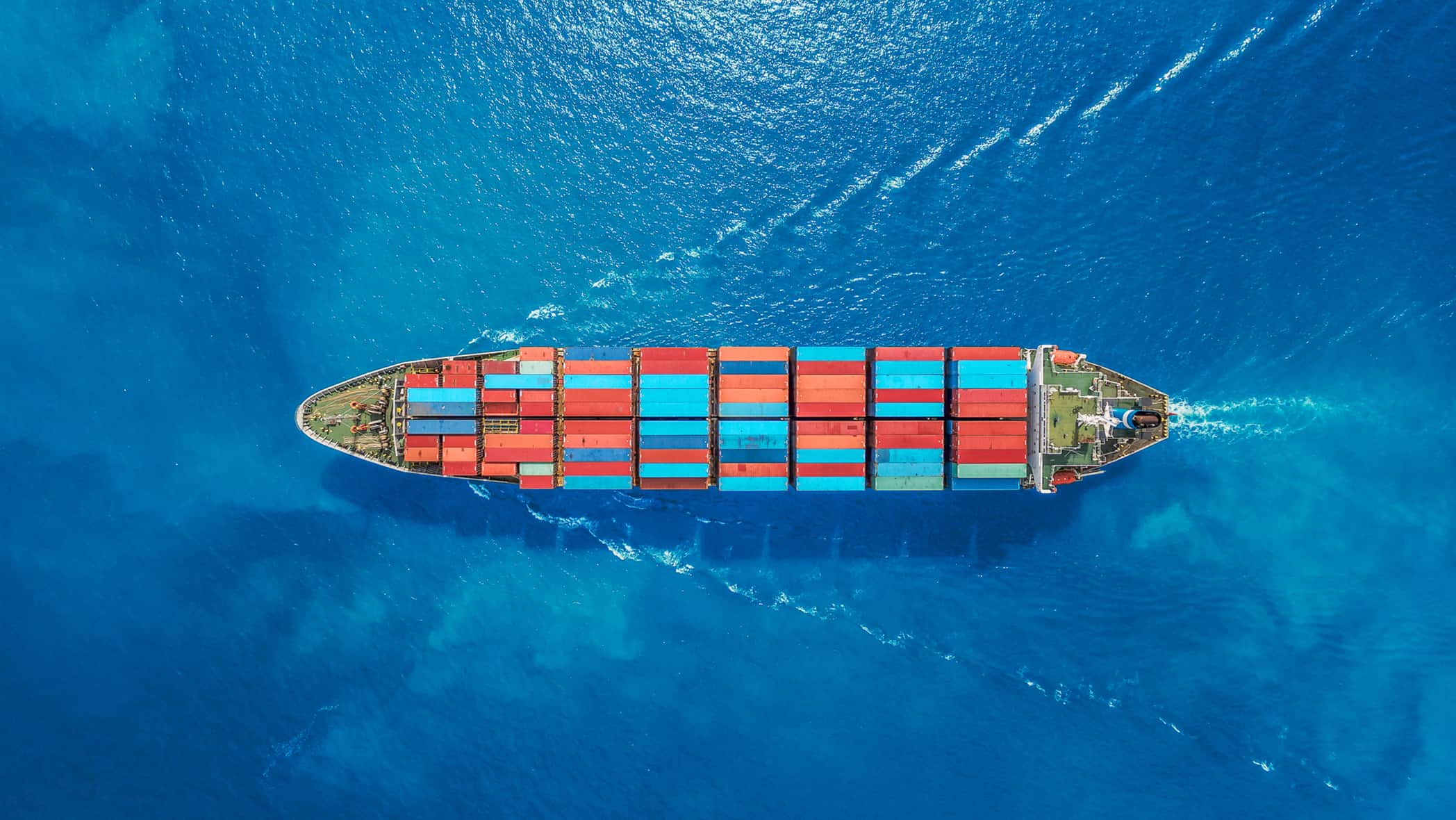 an overhead shot of a boat full of shipping containers