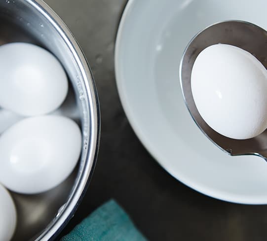 white eggs in a bowl with a spoon