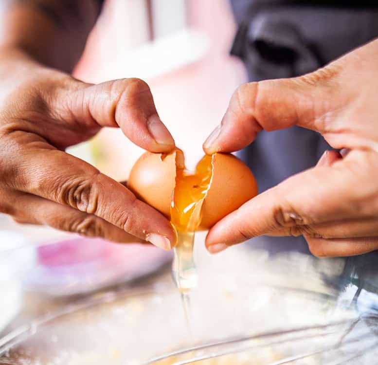 cracking open a brown egg