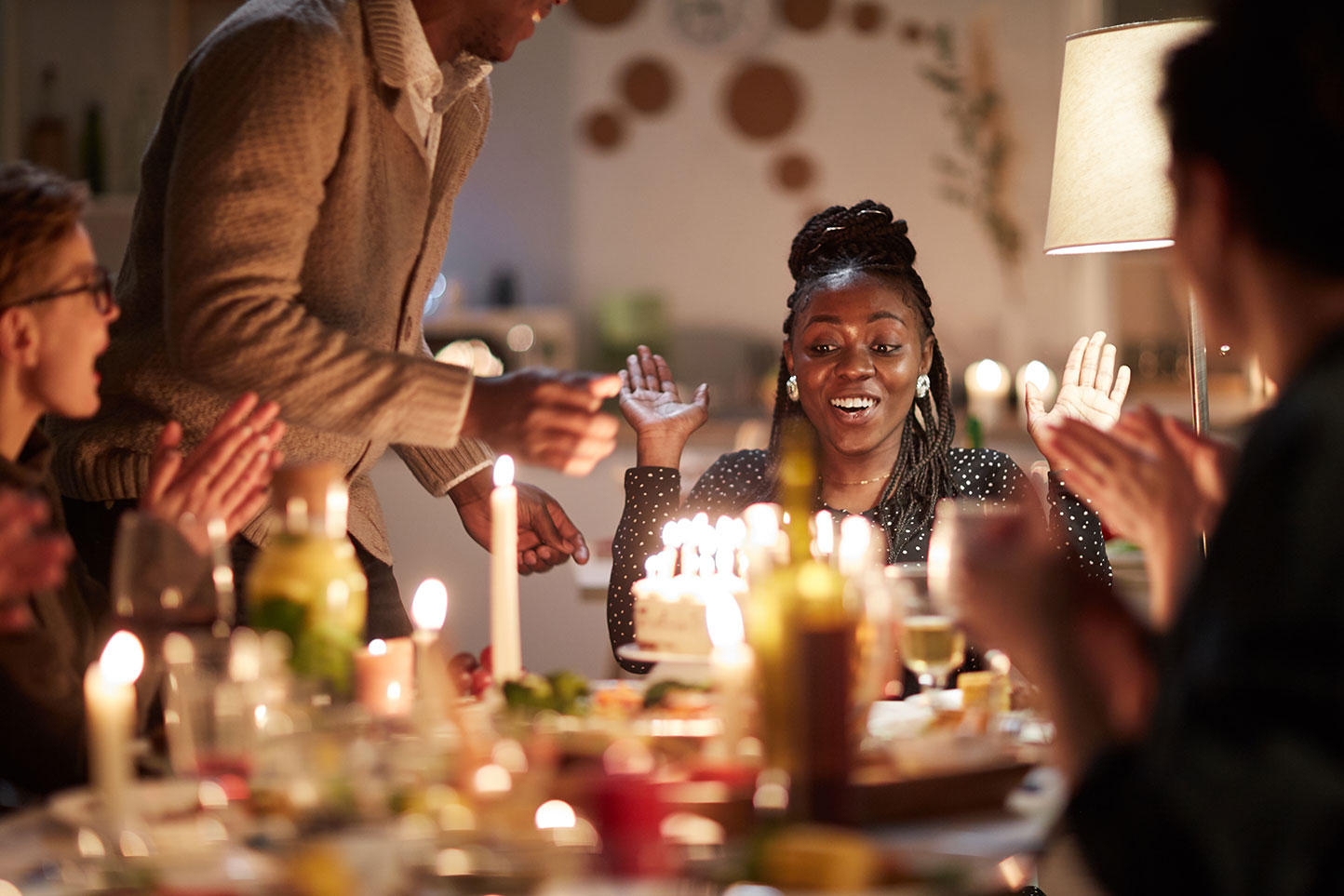 a woman celebrates with a birthday cake