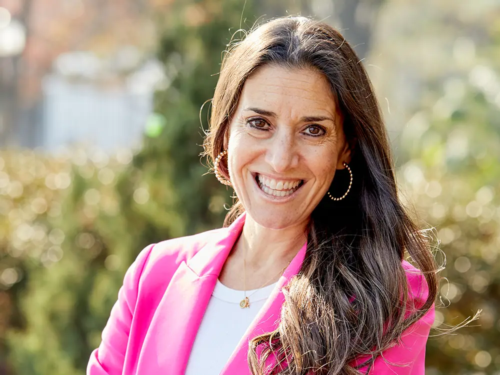 Woman outside standing in a pink suit