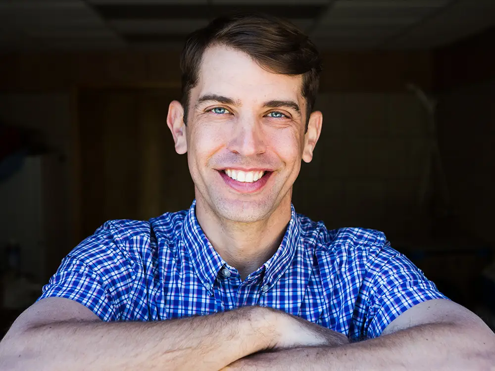 Doctor in plaid shirt with arms crossed