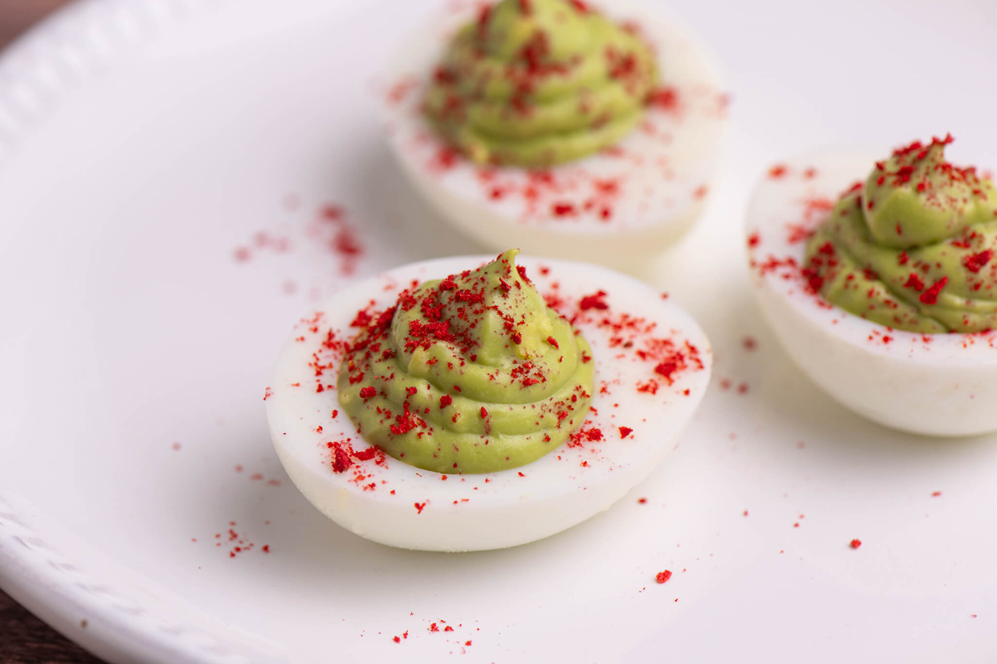 Matcha–Strawberry Deviled Eggs on a white plate