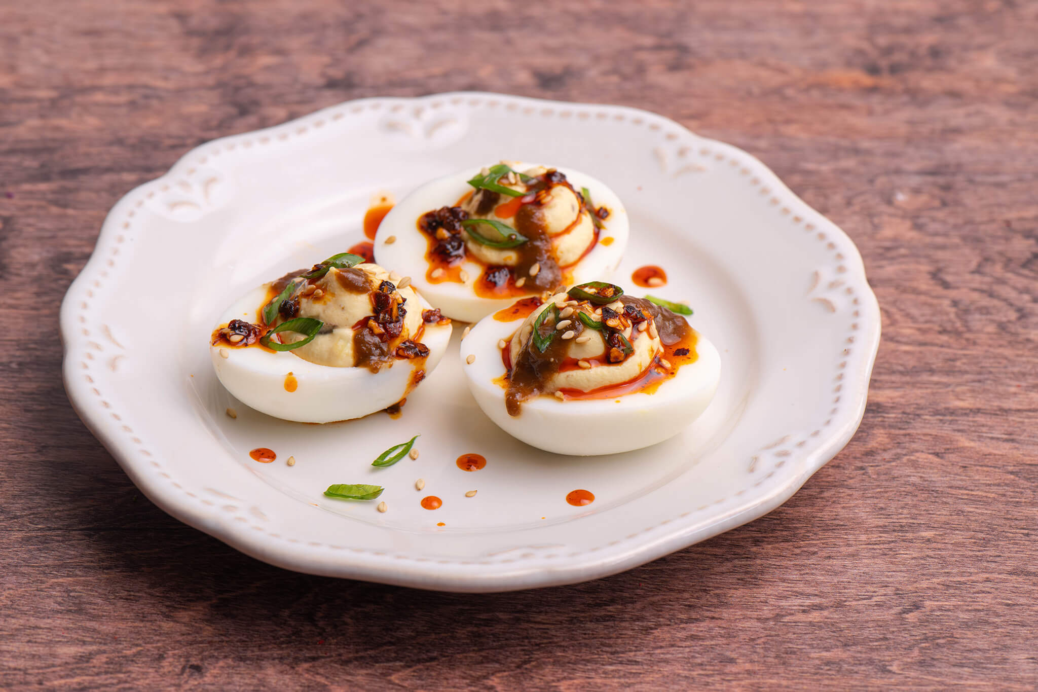 Miso-Black Garlic Deviled Eggs on a white plate